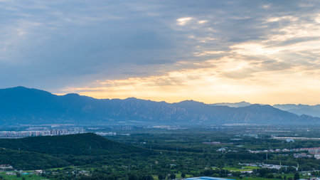 The urban green fields beneath the sea of clouds at Beijing's Baiwang Mountain, China.の写真素材