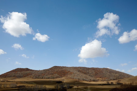 Autumn Wucaishan Mountain under blue sky and white clouds at Ulan Butong, Chinaの写真素材