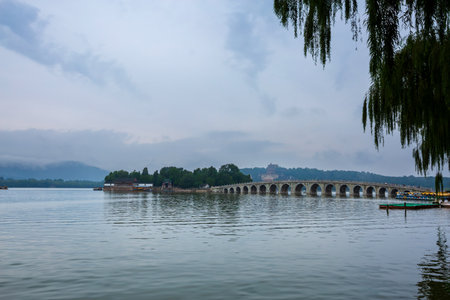 Seventeen-Arch Bridge misty rain scenery in Summer Palace, Beijing, Chinaの写真素材