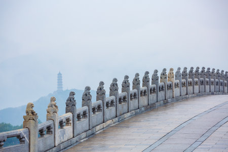 Seventeen-Arch Bridge misty rain scenery in Summer Palace, Beijing, Chinaの写真素材