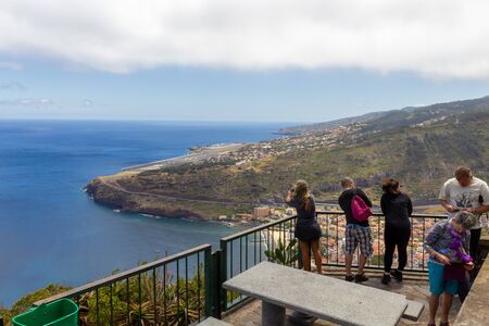 MACHICO, PORTUGAL - JULY 13, 2017: Tourists enjoying view over the bay of Machico and the Madeira airportのeditorial素材