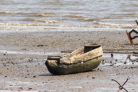 JUFUREH, GAMBIA- JAN 12, 2014: Boat to row are made from 1 tree, lying on shoreのeditorial素材