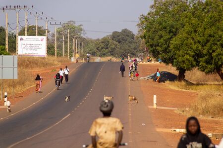 SANKANDI, GAMBIA- JAN 6, 2014: The main streets in Gambia are filled with walking peopleのeditorial素材