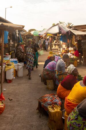SEREKUNDA, GAMBIA- JAN 9, 2014: Always busy at market in Gambia. It is the only place to buy and...