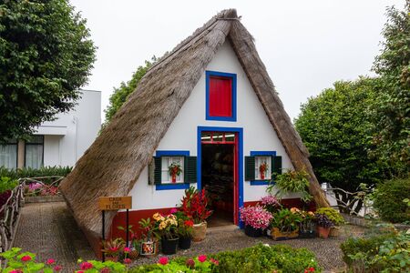 SANTANA, PORTUGAL - JULY 13, 2017: Traditional Madeira small house with flowers in Santana