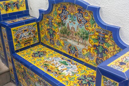 Firgas, Spain - Jan 4, 2010: In Firgas is a road  with tiles benches. Each bench represents a community on Gran Canaria. This is the Las Palmas bench with the Santa Ana cathedral in the middleのeditorial素材