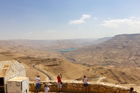 Wadi Mujib, Jordan - Sept 20, 2013: Tourists look over the Wadi Al Mujib valley with was formed in...