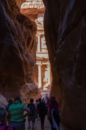 Petra, Jordan - Sept 21, 2013: Tourists reaching the Treasury building in Petra at the end of the walk trought the Al Siq canyon. It's a beautiful sight when you arriveのeditorial素材
