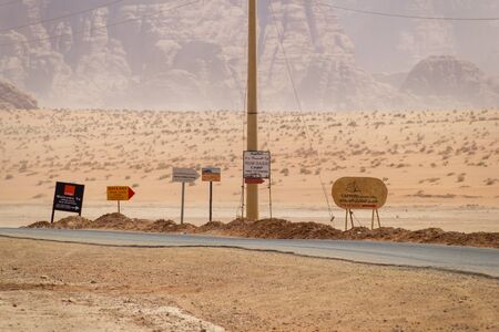 Wadi Rum, Jordan - Sept 22, 2013: Several camping signs beside a road in the Wadi Rum desert in Jordanのeditorial素材