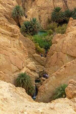 Water and tourists at the mountain oasis of Chebikaの写真素材