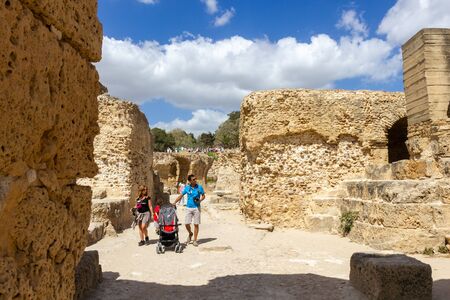 Tunis, Tunisia - 2 Sept, 2014: Tourist family walking trough the extivations of Carthage