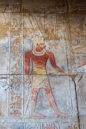 Painted pharaoh with hieroglyphs around on the wall at Karnak temple in Luxorの写真素材