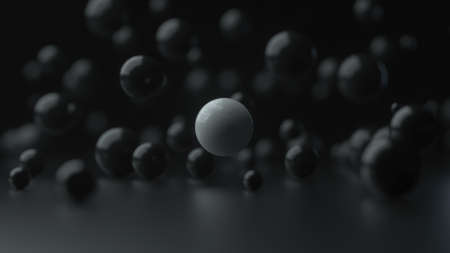 3D illustration of reflective black spheres and a white sphere in the middle on a black background. Depth of field render of many falling balls.の写真素材