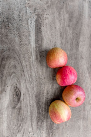 Four apples on wooden tableの素材