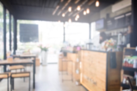 Blurred photo of coffee shop with wood table and counter.の写真素材