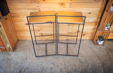 Tall chair made from wood and black metal.の写真素材