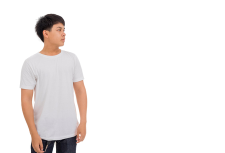 Photo of An Asian boy in white shirt with black hair standing in studio white background.の写真素材