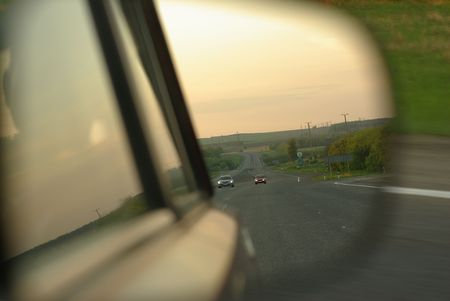 Road reflected in rear view mirrorの写真素材