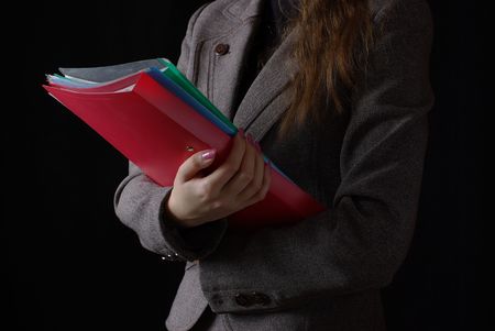 red folders in handの写真素材