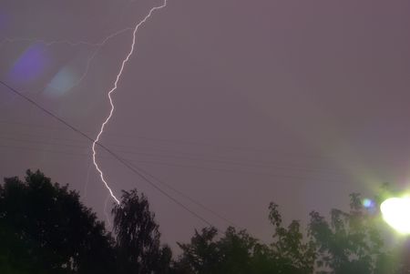 Night sky with lightning and a lanternの写真素材