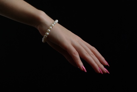 Hand with a pearl braceletの写真素材