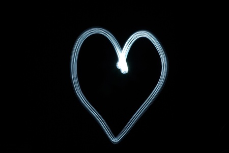Blue heart against the black backgroundの写真素材