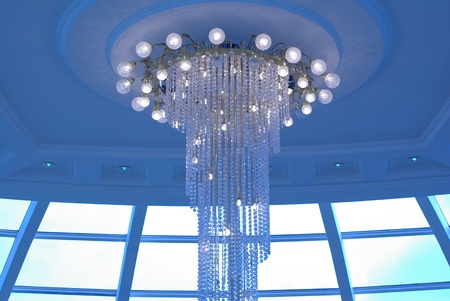 Crystal chandelier in the blue lightの写真素材