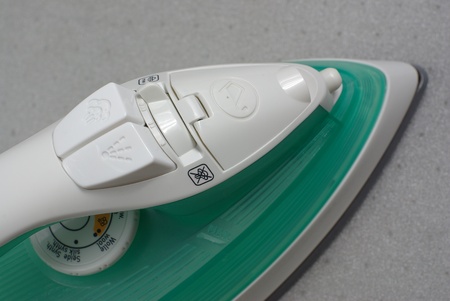 Steam iron on greyの写真素材