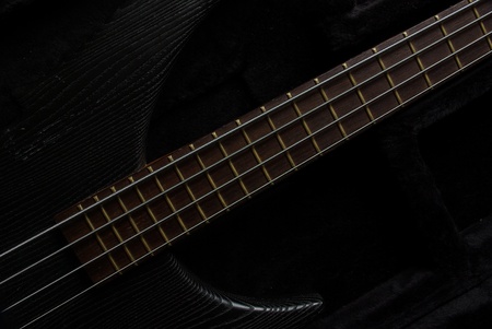 Bass guitar neck on the black, low key