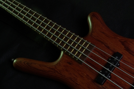 Bass guitar with brown body on blackの写真素材