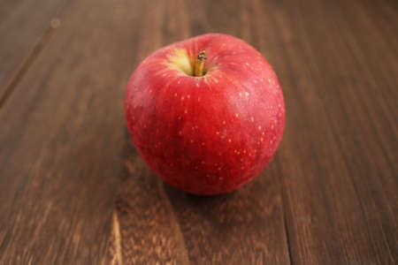 One apple on a wooden tableの写真素材