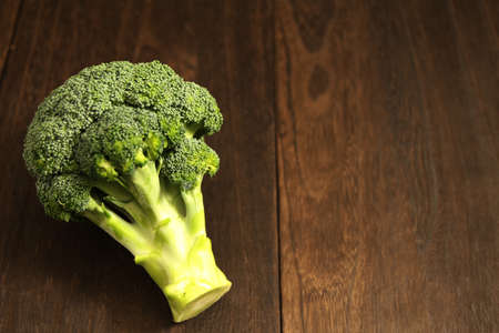 Broccoli on a wood-grained tableの写真素材