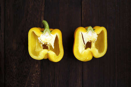 Half-cut paprika on a wooden tableの写真素材