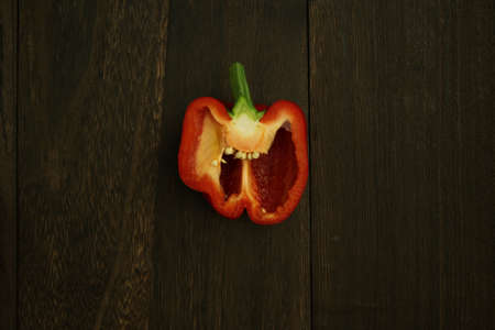 Half-cut paprika on a wooden tableの写真素材