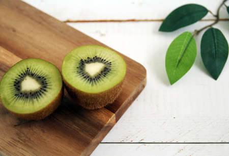 Kiwi cut in half on a wooden tableの写真素材