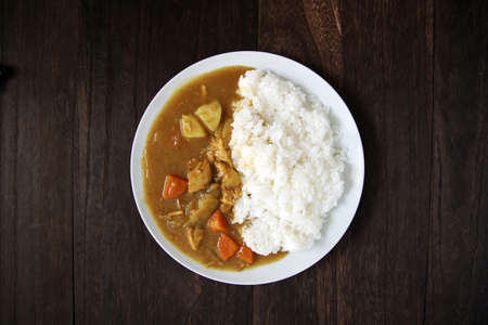Curry rice served at a restaurant on a wooden tableの写真素材