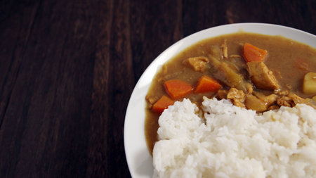 Curry rice served at a restaurant on a wooden tableの写真素材