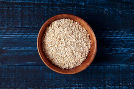 Instant oatmeal in a bowl on a blue tableの写真素材