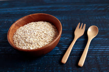 Instant oatmeal in a bowl on a blue tableの写真素材