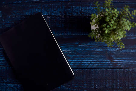 One notebook on the blue tableの写真素材