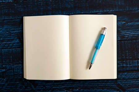 One notebook on the blue tableの写真素材