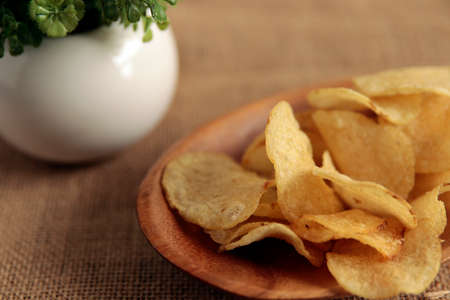Potato chips on a blue table with a lot of calories called mild drag