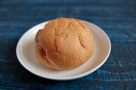 One cream puff on the table