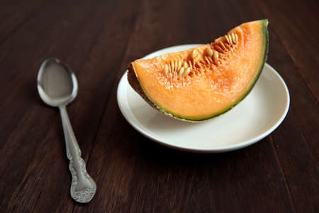 Cut pumpkin-like melon on the tableの写真素材