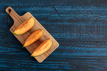 Cut pumpkin-like melon on the tableの写真素材