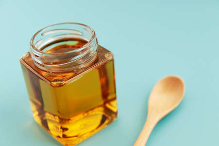 Honey in a cosmetological jar on the tableの写真素材