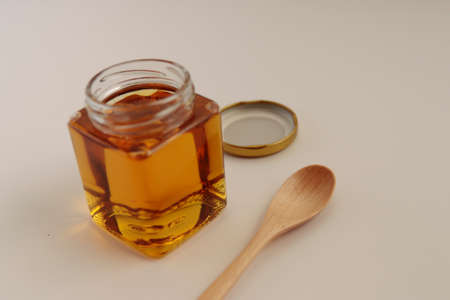 Honey in a cosmetological jar on the tableの写真素材