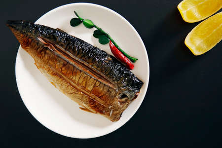Grilled fish dish mackerel on the tableの写真素材