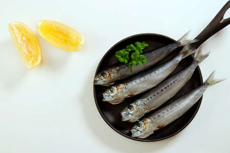 Squid that is the ingredient for multiple freshly caught fish dishes on the tableの写真素材