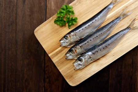 Squid that is the ingredient for multiple freshly caught fish dishes on the tableの写真素材